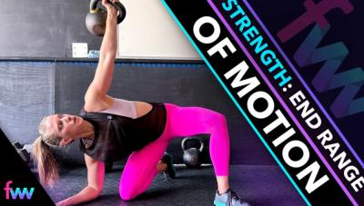 Kindal at the bottom of a forearm kneeling windmill pushing her hip mobility.