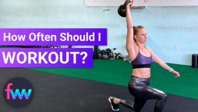 Kindal pressing a kettlebell over her head in a lunge.