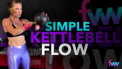 Kindal at the top of a kettlebell swing locking her body out and hitting the swing hard.