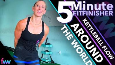 Kindal smiling as she rotates a kettlebell around her body doing the exercise called around the world.