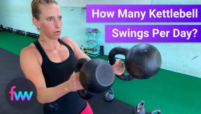 Kindal swinging two mismatched kettlebells.