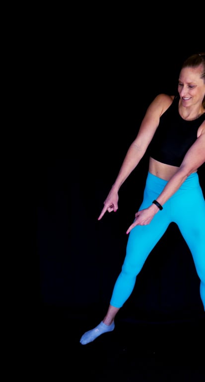 Kindal in s deep side kettlebell side lunge working her way through an intense metabolic strength workout.