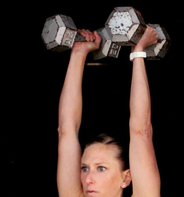 Kindal lifting two dumbbells over her head