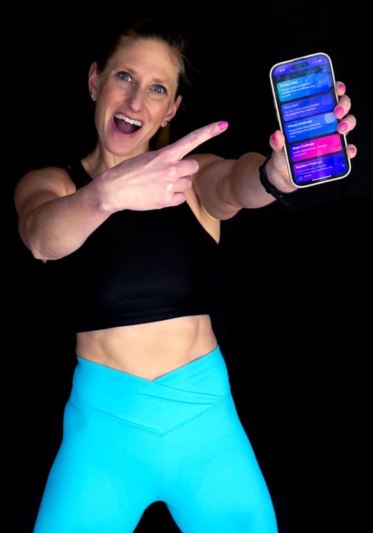 Kindal in s deep side kettlebell side lunge working her way through an intense metabolic strength workout.